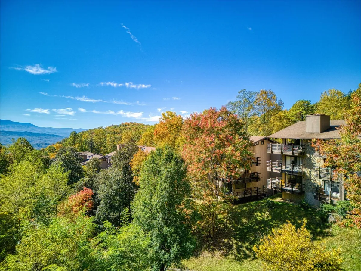 Balconies from the condo overlook a dramatic mountain view painted with vibrant autumn colors. The setting is quiet and private, making it an inviting spot for couples to enjoy coffee or savor the sunset together.